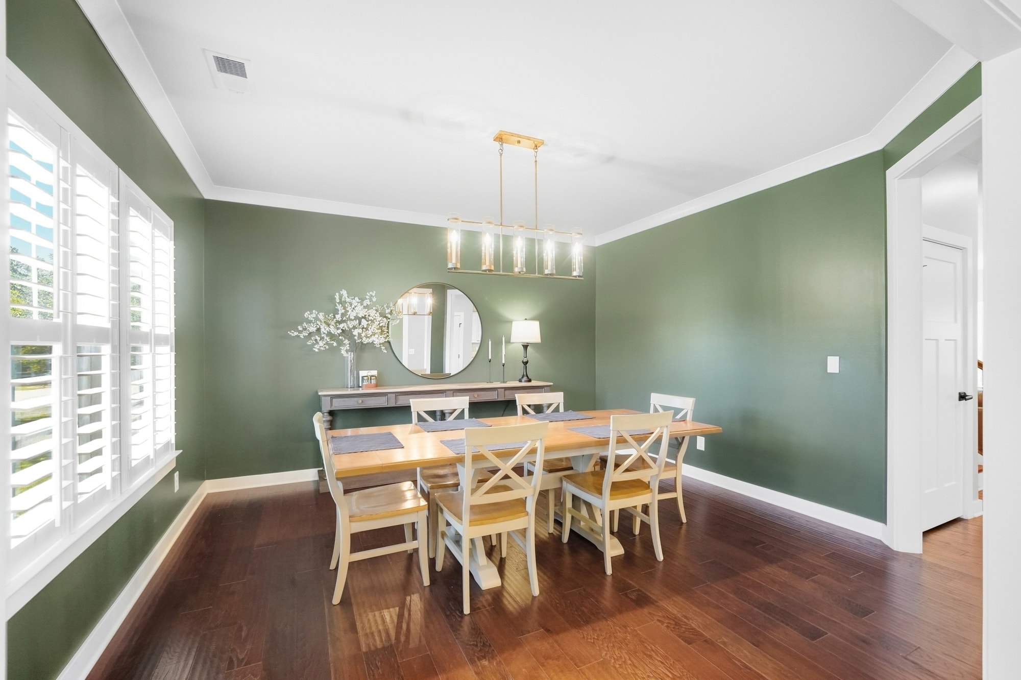 Formal dining room with sage green walls and gold chandelier at 912 Manorwood Drive Waxhaw NC