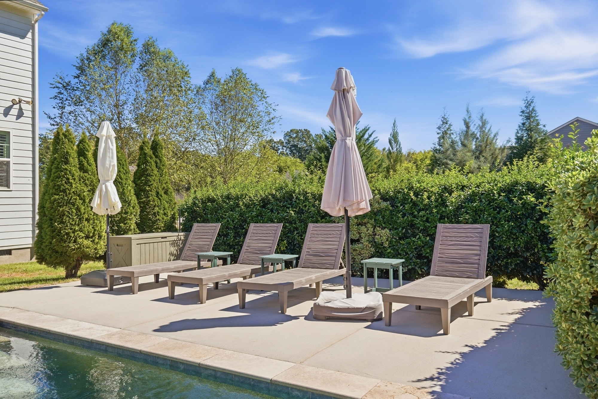 Pool deck with lounge chairs and umbrellas at 912 Manorwood Drive, Waxhaw NC
