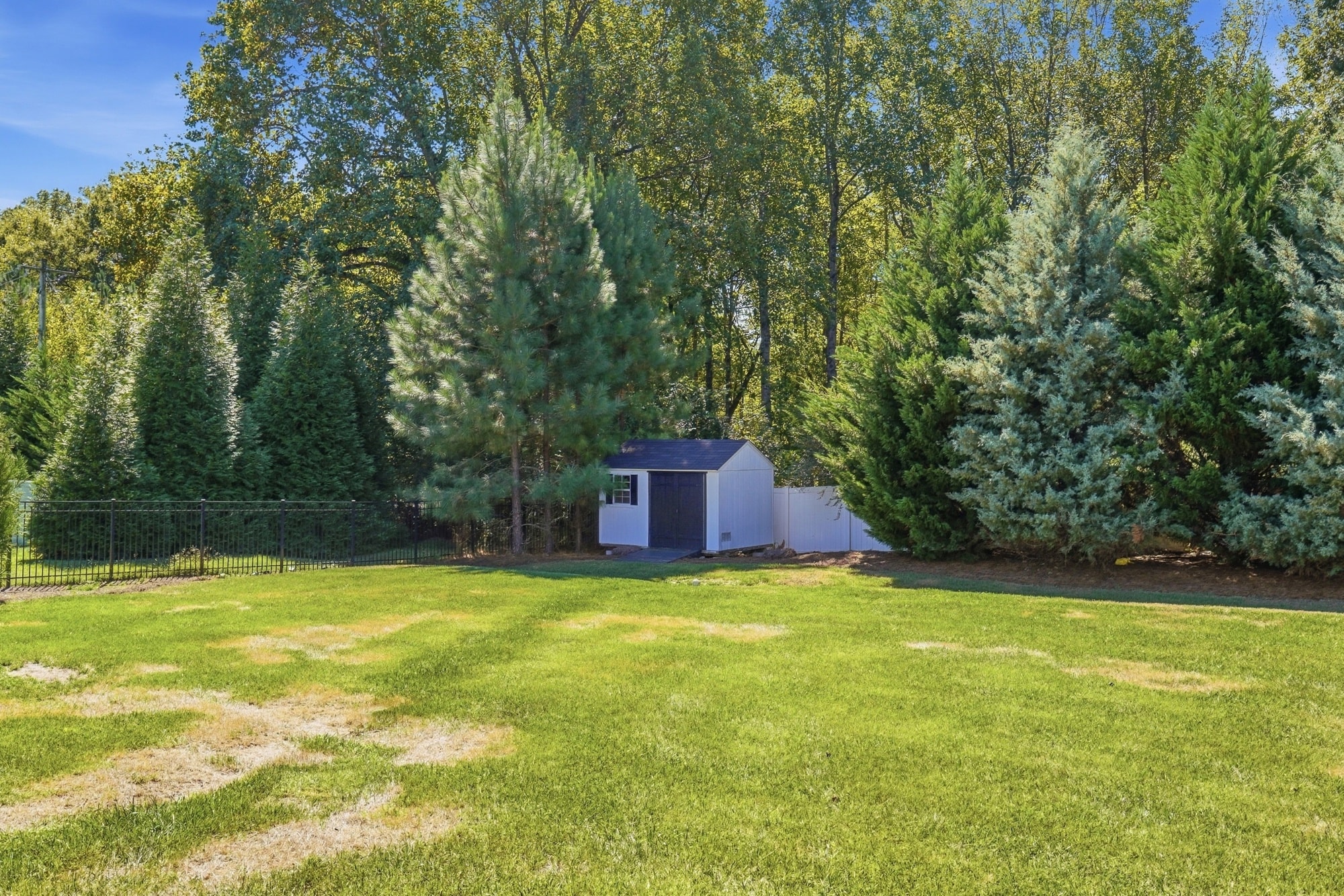 Storage shed and open lawn showing the full depth of the lot at 912 Manorwood Drive, Waxhaw NC