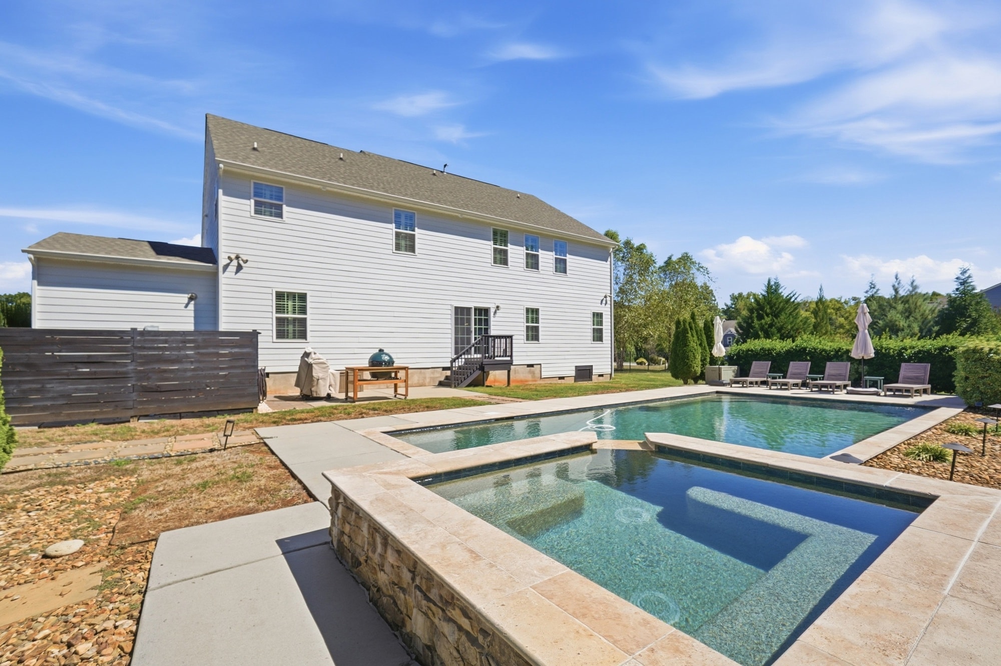 Heated saltwater pool and spa with lounge seating and mature landscaping at 912 Manorwood Drive, Waxhaw NC